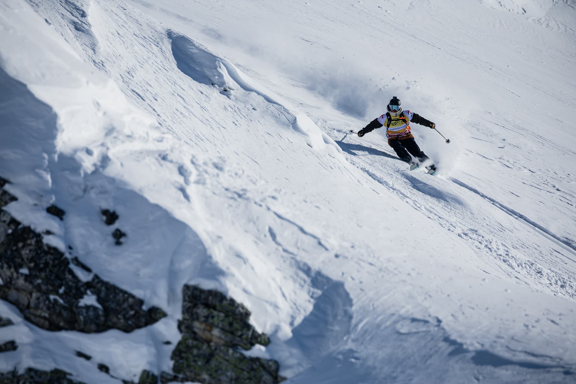 Marcus Goguen carving down a big-mountain face in deep powder